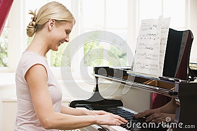 Woman playing piano Stock Photo