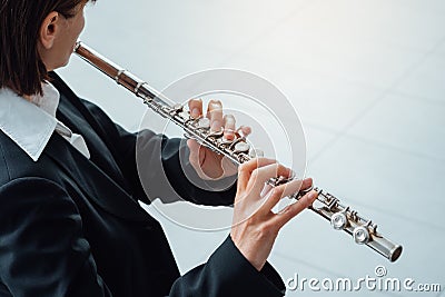 Woman playing transverse flute Stock Photo