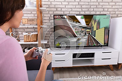 Woman Playing Video Game With Joystick Stock Photo