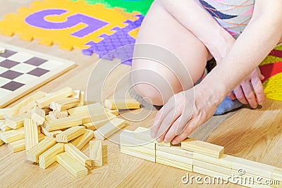 Woman playing wood blocks.Concept of board games Stock Photo