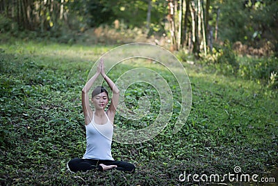 Woman playing yoga garden field weekend holiday lifestyle park outdoor nature Stock Photo