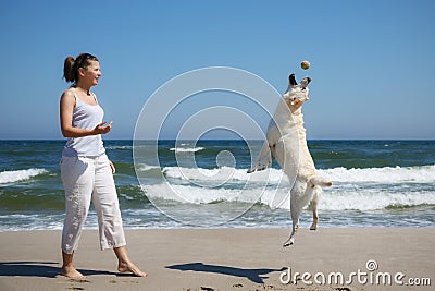 Woman plays with dog Stock Photo