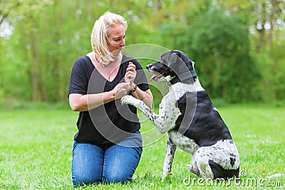 Woman plays with her dog outdoors Stock Photo