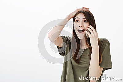 Woman plesantly shocked being happy for friend who won in lottery. Excited joyful young female in casual clothes Stock Photo