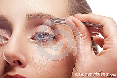 Woman plucking eyebrow Stock Photo