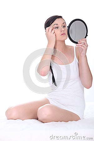 Woman plucking eyebrows Stock Photo