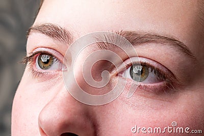 Woman plucking eyebrows with tweezers. Stock Photo