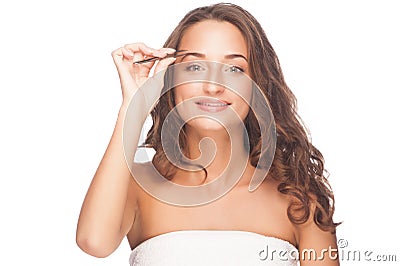 Woman plucking eyebrows Stock Photo