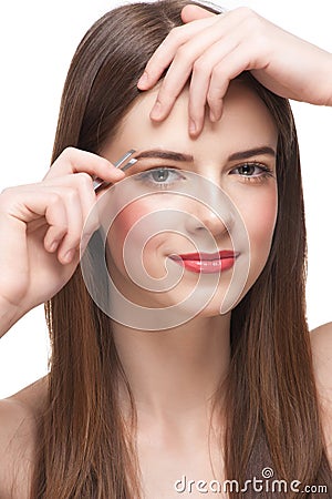 Woman plucking her eyebrows Stock Photo