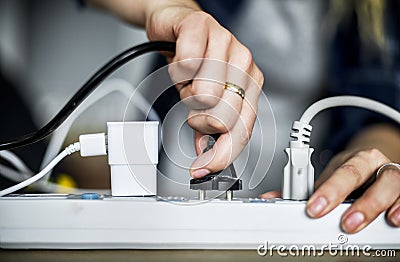 Woman plugging the wire Stock Photo