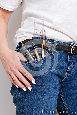 Woman pocket in jeans with pens and pensil Stock Photo