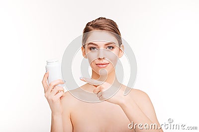 Woman pointing finger on bottle with pills Stock Photo