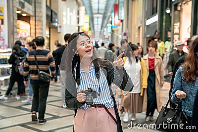 Woman pointing at somewhere joyfully. Editorial Stock Photo