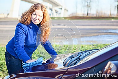 Woman polishing car cowl Stock Photo