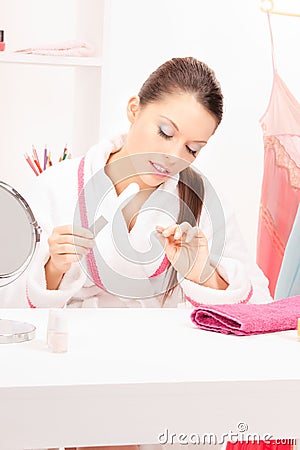 Woman polishing her nails Stock Photo