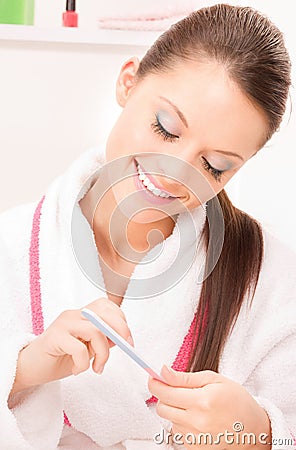 Woman polishing her nails Stock Photo