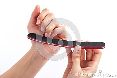 Polishing Nail Perfection: Woman Nails It with Nail File Stock Photo