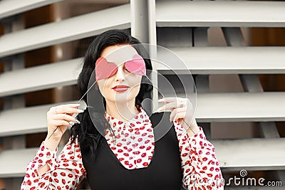 Woman portrait close holding in his hand the hearts from the cardboard paper near the face Stock Photo
