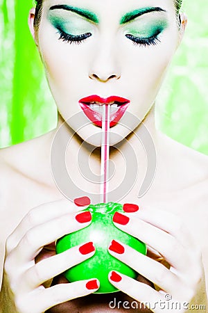 Woman portrait drinking apple juice with straw Stock Photo