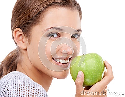 Woman, portrait and eating apple, nutrition and gut health with snack or meal, diet for weight loss on white background Stock Photo