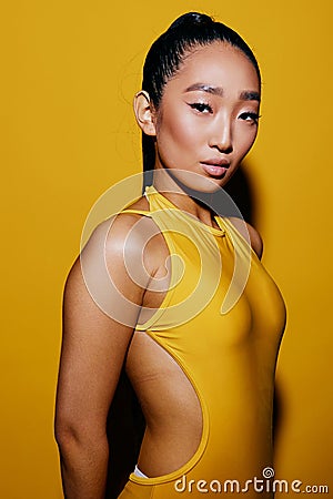 One woman yellow summer portrait asian beauty surprised trendy smile fashion swimsuit shocked Stock Photo