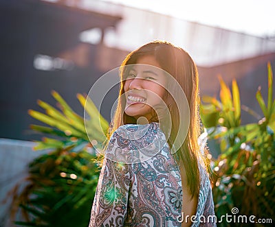 Woman portrait with sunflare on with construction site on the background for developing city woman cocnept Stock Photo