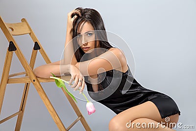 Woman posing in the black lingerie with flower Stock Photo