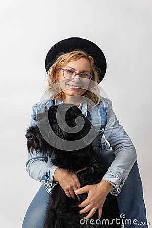 Woman is posing with her Big Schnauzer Dog Stock Photo