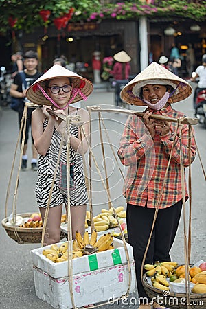 Tourist and fruit vendor, Hoi An, Vietnam Editorial Stock Photo