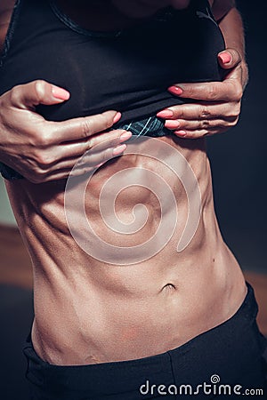 Woman posing with perfect abdomen muscles Stock Photo