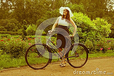 Woman posing with retro bicycle in the park Editorial Stock Photo