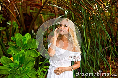 Woman posing in the shadows of the palms Stock Photo