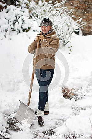 Woman posing with snow shovel Stock Photo
