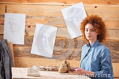 Woman potter working with clay in workshop Stock Photo