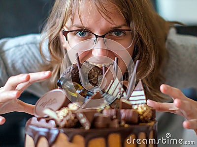 Woman pounces on the cake. Girl wants to eat a beautiful cake. Concept of refusal from the diet in women Stock Photo