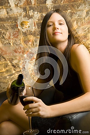 Woman pouring glass of wine Stock Photo
