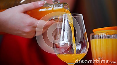 A woman pouring a juice from the bottle in the glass Stock Photo