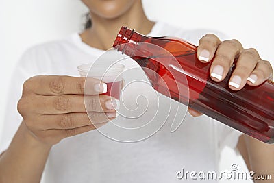 Woman Pouring Medicine Stock Photo