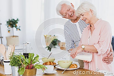 Woman pouring milk Stock Photo