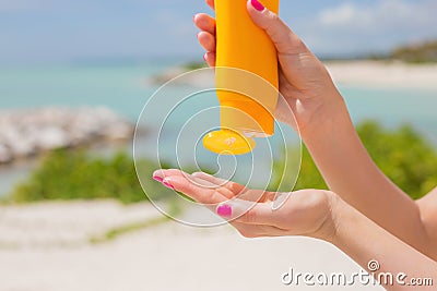 Woman pouring sunscreen in hand Stock Photo