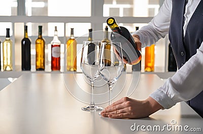 Woman pouring tasty wine in glass on table Stock Photo
