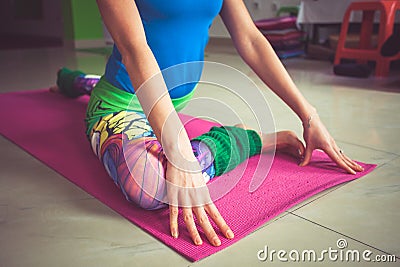 Woman practice yoga indoor extension of lower limbs closeup Stock Photo