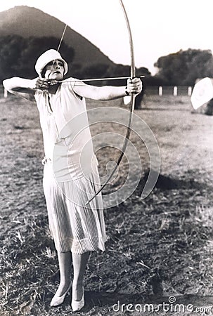 Woman practicing archery Stock Photo