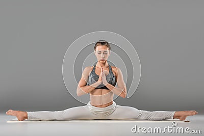 woman practicing wide angle seated forward bend Stock Photo