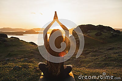 Woman practicing yoga outdoors. Spiritual harmony and well-being concept Stock Photo