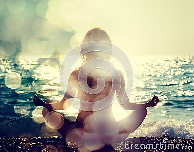 Woman Practicing Yoga by the Sea Stock Photo