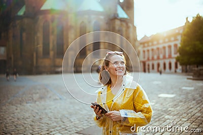 woman in Prague having walking tour, using phone and walking Stock Photo