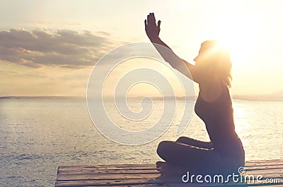 Woman in prayer is in harmony with itself and the nature Stock Photo