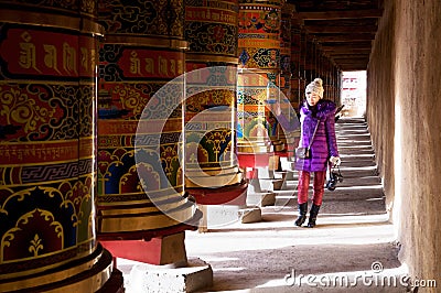 Woman and Prayer Wheel Stock Photo