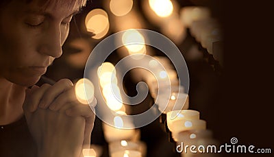 Woman praying in Catholic church Stock Photo